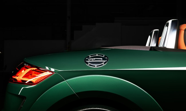 2023 Audi TT Roadster Final Edition view across the right rear quarter panel of the green car in an empty warehouse